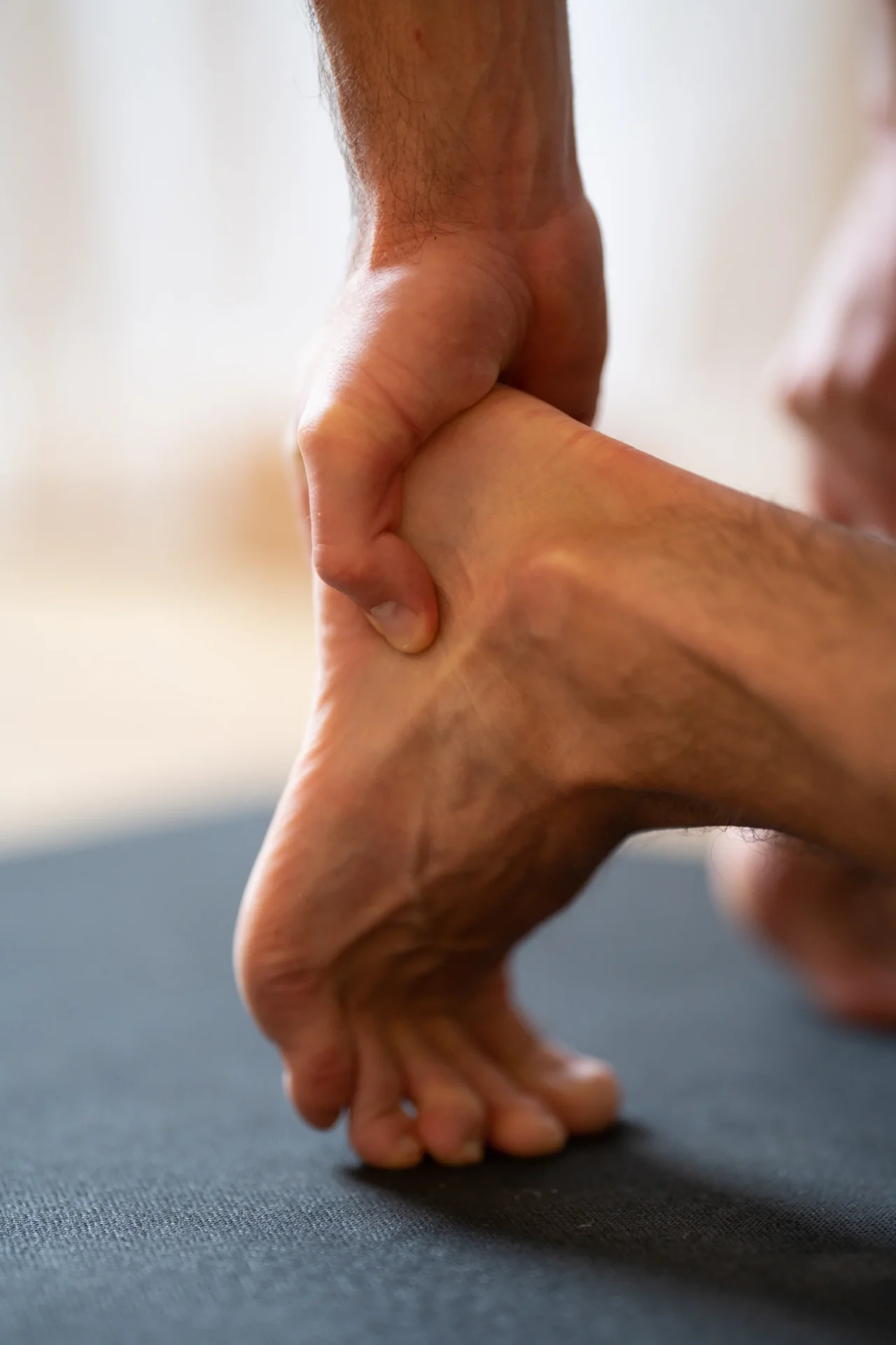 adult man massaging his foot on a mat 2026 03 18 09 29 32 utc 1