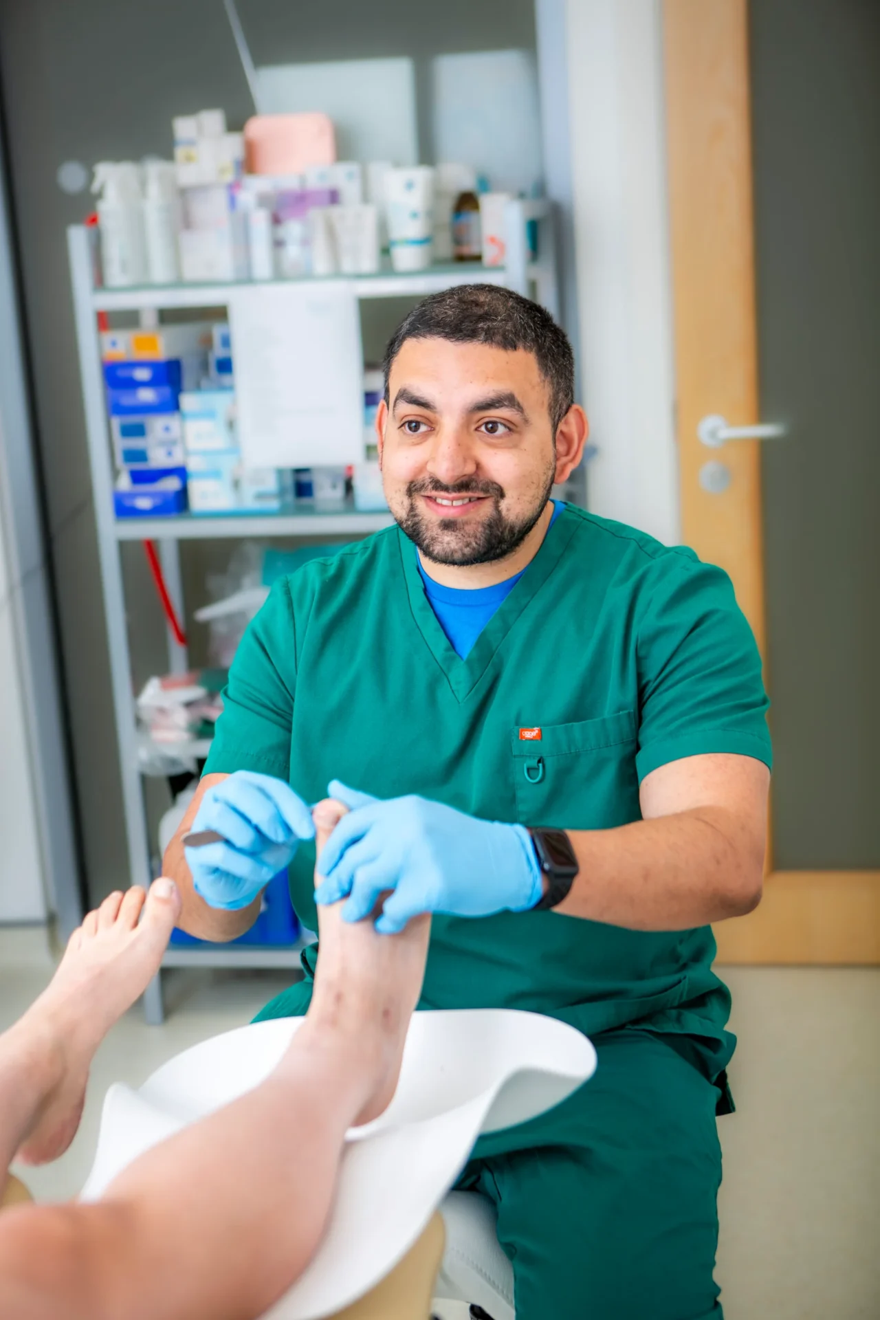 Podiatrist Tristan Valeny treating a patient's foot at Sussex Total Foot Care